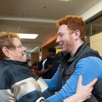 Lynn M. Blue hugging a guest at the Lynn M. Blue Connection Naming Ceremony